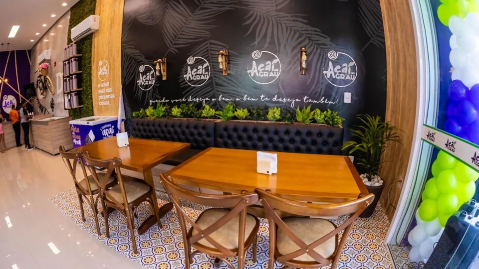 Área interna com mesas da loja Açaí no Grau